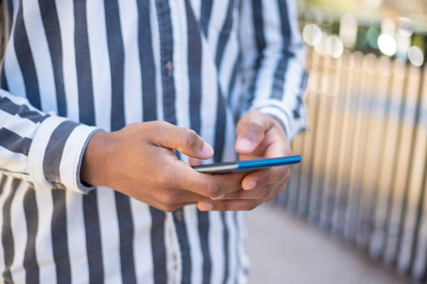 istock Cropped view of man texting on smartphone 1216347795