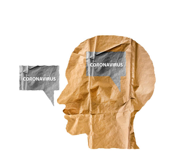 istock Crumpled paper shaped as a human head and talk balloon on white. Paper human head with Coronavirus text. COVID-19 crisis concept. 1216348043