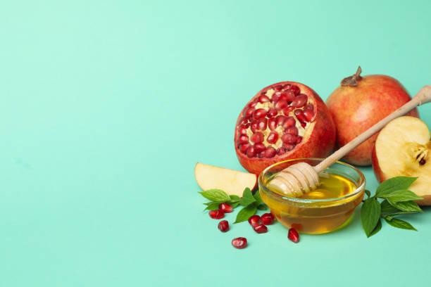 istock Apple, honey and pomegranate on mint background. Home treatment 1216348697