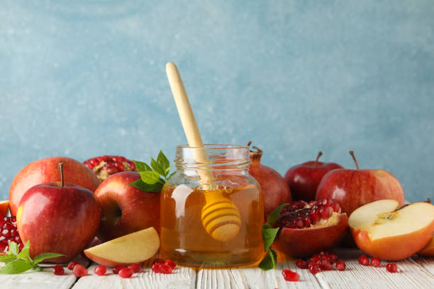 istock Apples, pomegranate and honey on wooden table, close up 1216348979