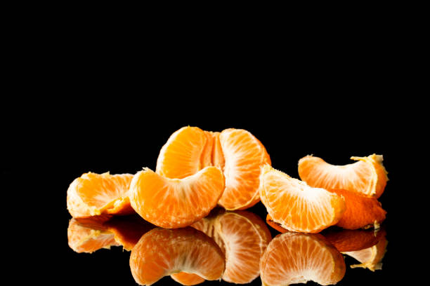 istock fresh tangerine on a black background with a beautiful reflection 1216349991