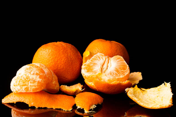 istock fresh tangerine on a black background with a beautiful reflection 1216349993