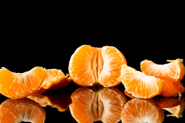 istock fresh tangerine on a black background with a beautiful reflection 1216350017