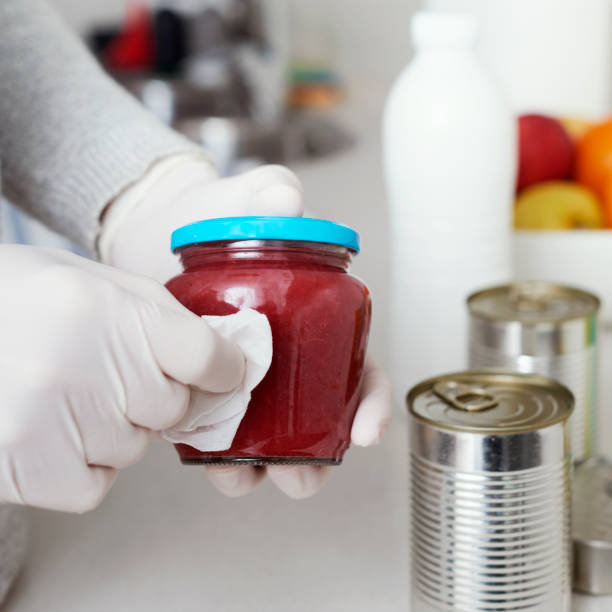 istock man disinfecting the purchases 1216350604