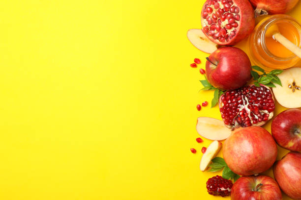 istock Apple, honey and pomegranate on yellow background, space for text 1216350611