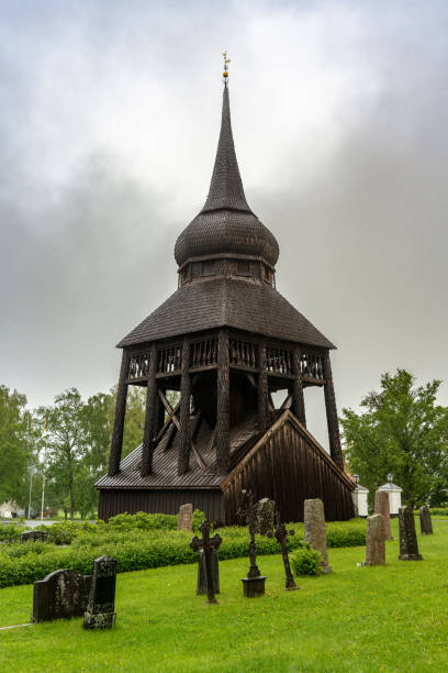 istock Medieval wooden church tower with cemetery in front 1216350882