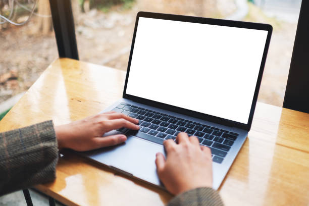istock a woman using and typing on laptop computer with blank white desktop screen on wooden table 1216351231