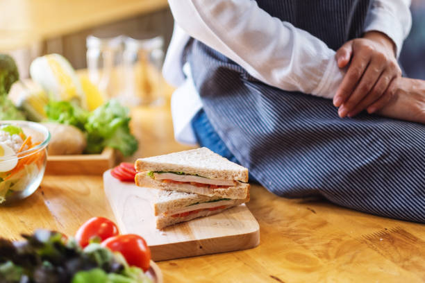 istock a female chef cooking whole wheat sandwich in kitchen 1216351934