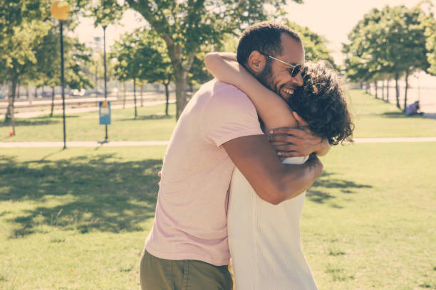 istock Happy multiethnic friends hugging in park 1216353226