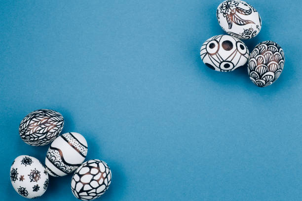 Easter eggs are painted in black and white lie in the corners diagonally