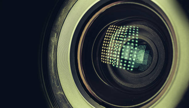istock CLOSE UP Beautiful camera lens with light reflection on a black Background pattern for design. 1216354845