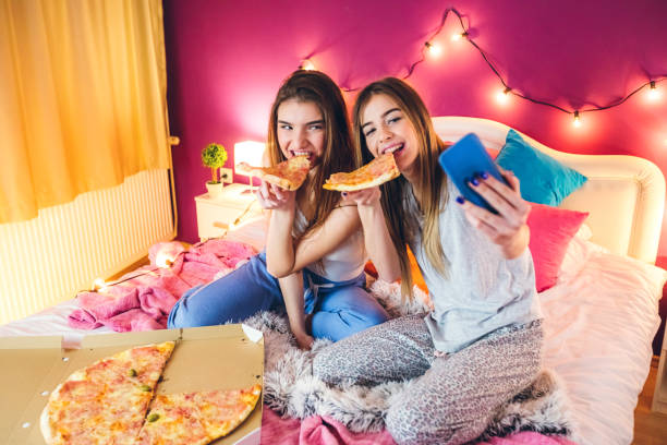 istock Eating pizza at slumber party 1216356217