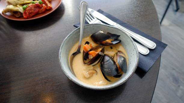 istock a dish with mussel, shrimp and carrot soup just served 1216356757