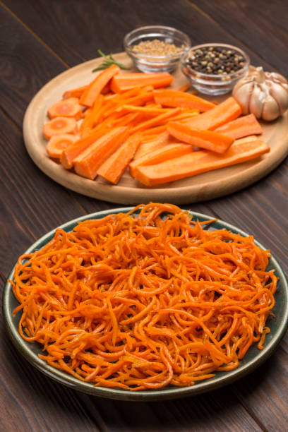 istock Fresh chopped carrots on cutting board. Fermented carrots in plate. 1216358095