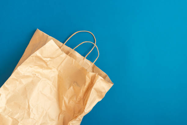 Paper bag for products on blue background stock photo