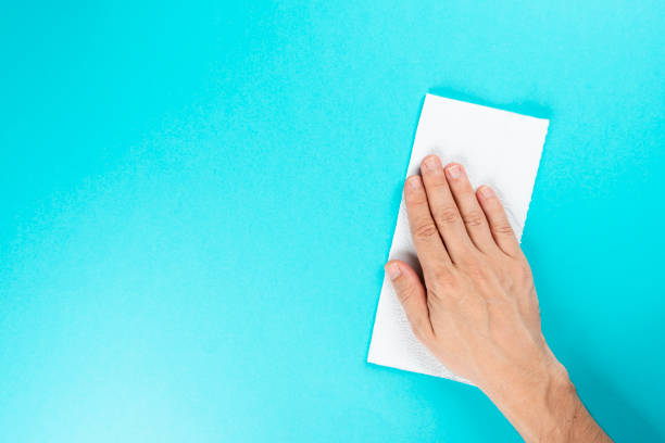 istock Man with disposable fabric for cleaning with 70% alcohol, Wiping down surface concept 1216359291
