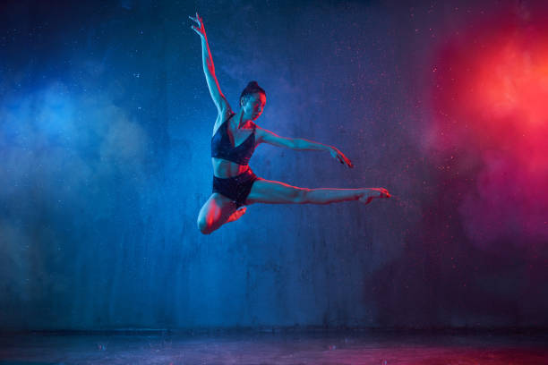 istock Slim ballerina jumping under rain. 1216360624