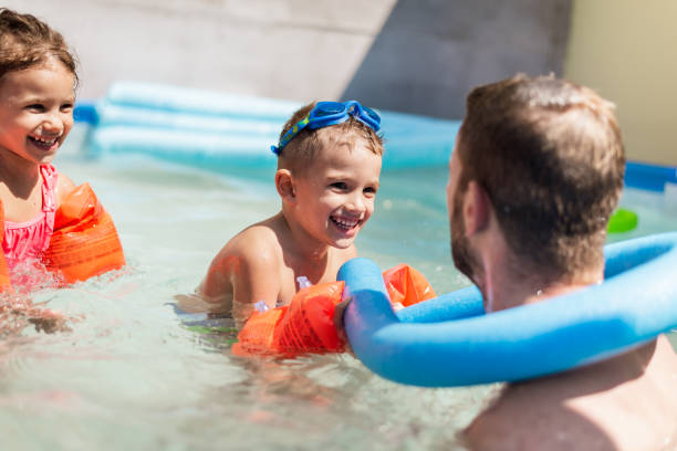 istock Children games in swimming pool 1216362357
