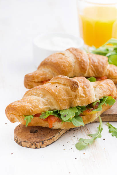 istock fresh croissant stuffed with fish and arugula for breakfast 1216362415