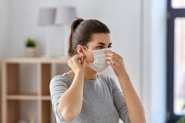 istock young woman wearing protective medical mask 1216364098