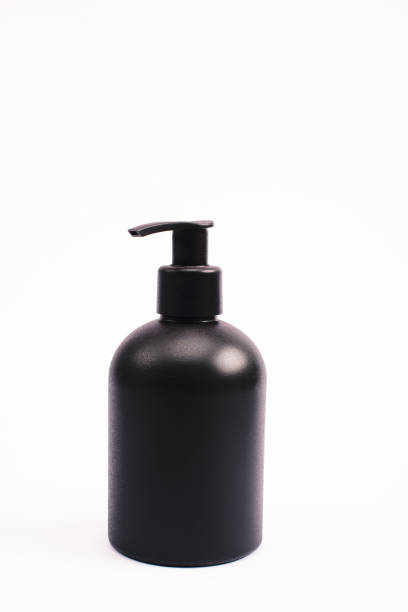 istock black bottle with body lotion isolated on white 1216366051