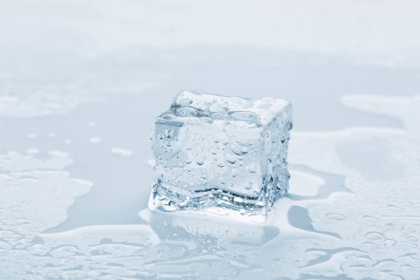 istock several melted ice cubes with drops on a light background with blue tinting 1216367733
