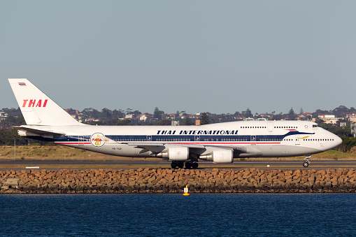 Sydney, Australia - October 9, 2013: Thai Airways International Boeing 747 jumbo jet HS-TGP in retro Thai Airways Livery taxis for departure from Sydney Airport.