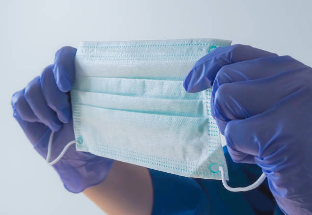 istock Nurse holding protection face mask against coronavirus 1216369057