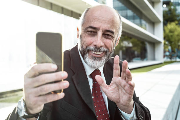 istock Content businessman waving hand during video chat 1216369704