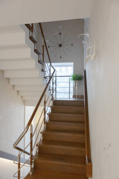 istock Staircase between floors with metal railing. Brown steps. 1216369781