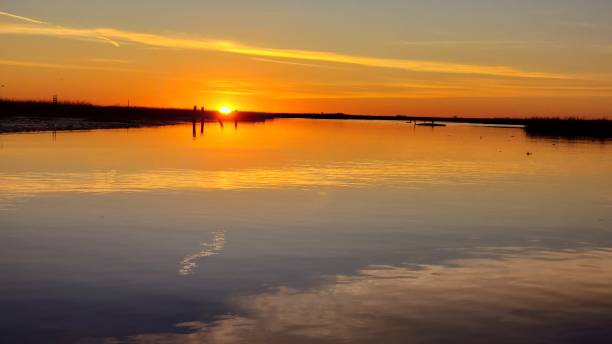 istock Winter sunrise over water. 1216370020