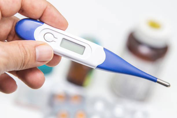 istock Pills and medical thermometer on white background 1216373621