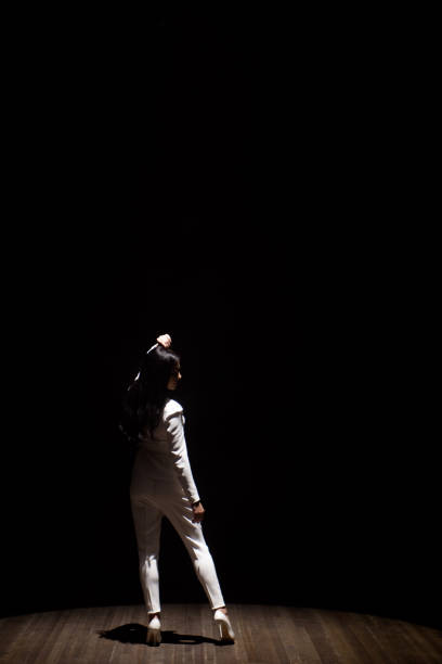 istock Woman model on stage demonstrates a trouser white suit 1216375227