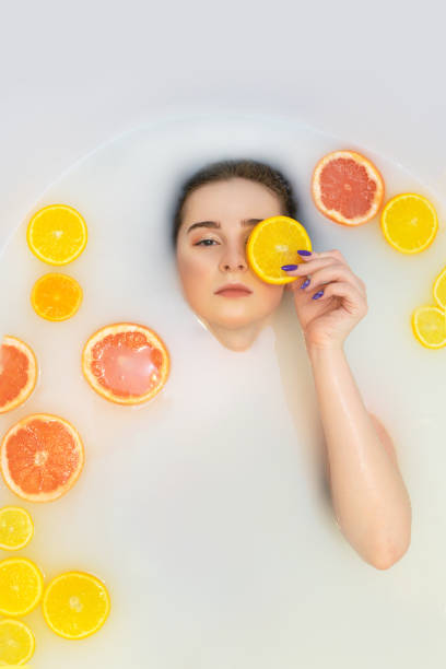 istock Pretty girl in bath with orange lemon. 1216377860