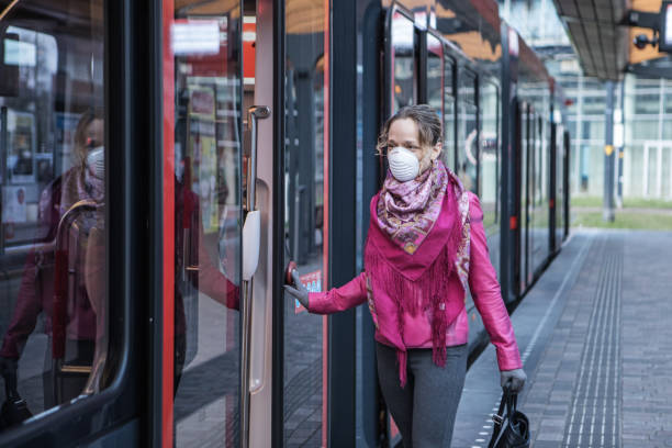 istock Female commuter using public transport during virus outbreak 1216378116