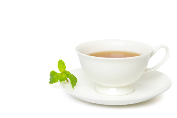 istock Tea in white cup with leaf mint isolated on white background. 1216378635