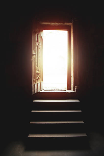 istock Light entering through open door in church 1216379140