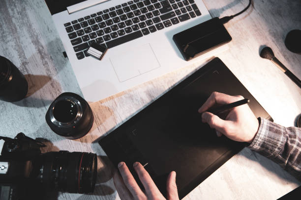 istock photographer man hand graphic tablet on desk 1216379643