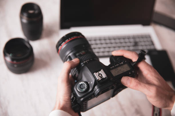 istock photographer man hand  camera on desk 1216379711