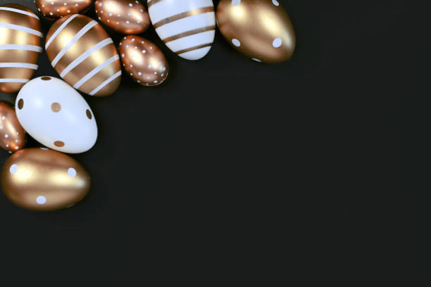 istock Flat lay with goldenand white easter eggs painted with stripes and dots on black background with blank copy space 1216379764
