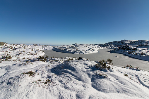 Upper plateau of Serra da Estrela covered with snow in winter, with some frozen lagoons.