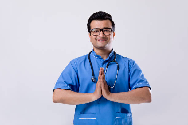 istock Male nurse greeting with namaste over white background 1216381332