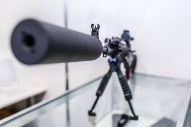 Sound suppressor or sound moderator and Iron sights on the gun barrel of semi-automatic rifled carbine, standing on stand. Iron sight in shallow DoF(depth of field). Sound suppressor or sound moderator and Iron sights on the gun barrel of semi-automatic rifled carbine, standing on stand. Iron sight in shallow DoF(depth of field). armory photos stock pictures, royalty-free photos & images