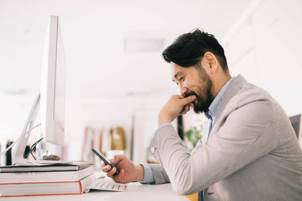istock Man sitting behind the desk, smiling 1216384029
