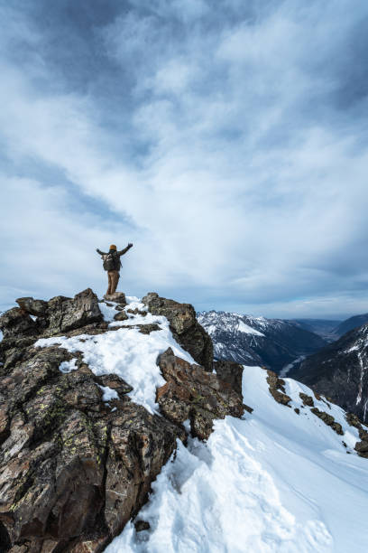 istock Man with outstretched arms on top of a mountain 1216384371