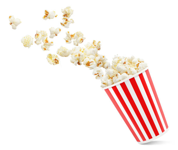 istock Popcorn flying out of red-white striped paper cup on white 1216384374