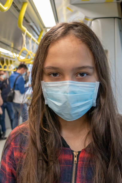 istock Young tween girl wearing surgical mask on subway 1216384868
