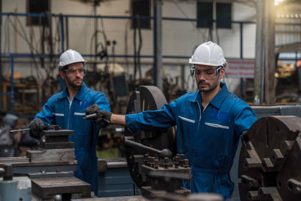 istock Professional technicians and two engineers are working in industrial plants. Professional technicians and engineers are working in fatory plants that work on steel. Working together. 1216386619