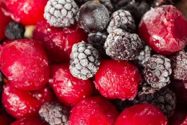istock Close up of frozen mixed fruit, berries - cherry, raspberry, blackberry, black currant, blurred background 1216387146