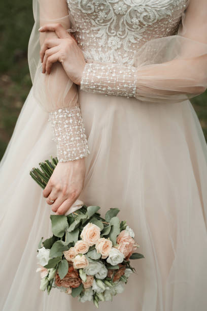 istock Bride stands outside with a bouquet 1216389649